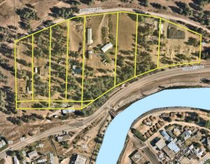 satellite map of 9 impacted properties in Princeton BC due to unstable slope. Image has a yellow overlay drawing the borders of the impacted properties.